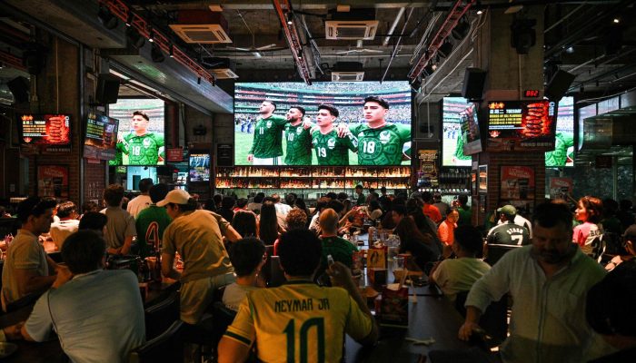 115229996-people-watch-the-opening-match-of-the-2026-world-cup-football-tournament-between-mexico-an.jpeg
